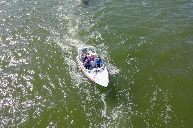 Mangrove and Lagoon Speed Boat Tour - Open water, hotel views, and mangrove turns