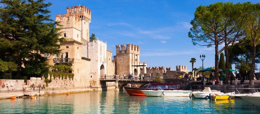 Sirmione: Walking and Speedboat Tour - Crossing the Bridge Into the Walled Town