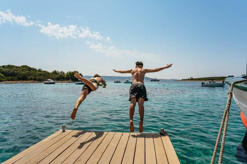 Split: Blue Lagoon & 3 Islands Small Group Speedboat Tour - Blue Lagoon: clear water, rocky shore, and a busy beach bar